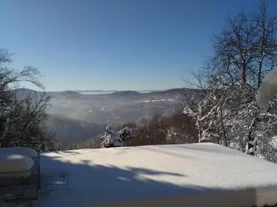 a snow covered hill with a view of a valley at Bed&Breakfast Zilje in Vinica