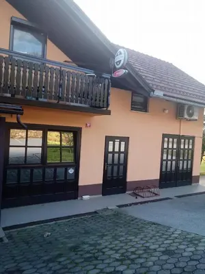 a house with black doors and a balcony at Bed&Breakfast Zilje in Vinica
