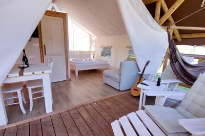a living room with a hammock in a tent at Glamping SUN VALLEY Bioterme in Mala Nedelja