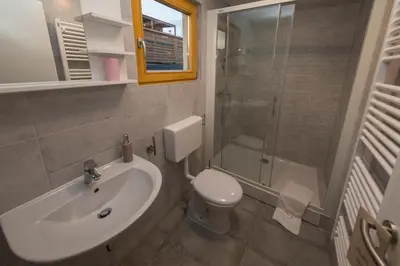 a bathroom with a sink and a toilet and a shower at Glamping SUN VALLEY Bioterme in Mala Nedelja