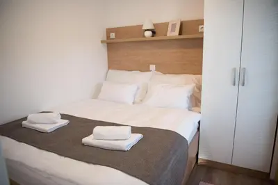 a bedroom with a bed with two towels on it at Glamping SUN VALLEY Bioterme in Mala Nedelja