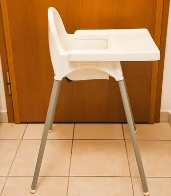 a white chair sitting under a sink in a room at Apartma Manca in Kranjska Gora