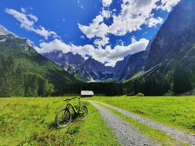 a bike parked on the side of a dirt road at Apartma Manca in Kranjska Gora