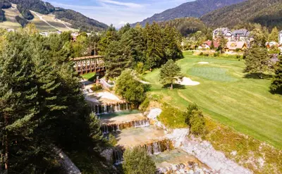 an aerial view of a resort with a river and trees at Apartma Manca in Kranjska Gora