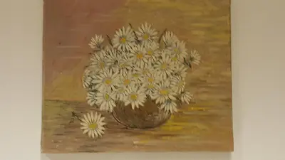 a painting of a vase of flowers on a table at Hiša marjetica in Maribor