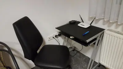 a black desk with a chair and a laptop on it at Hiša marjetica in Maribor