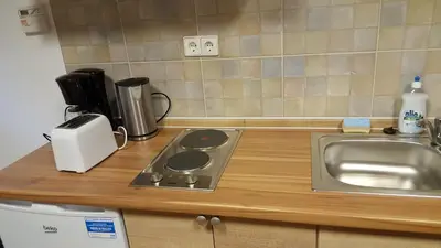 a kitchen counter with a stove and a sink at Hiša marjetica in Maribor