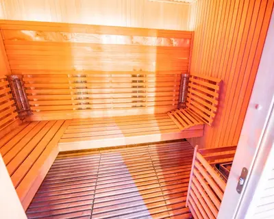 a large empty sauna with wooden walls and ceilings at Vila Triglav on Pokljuka in Goreljek