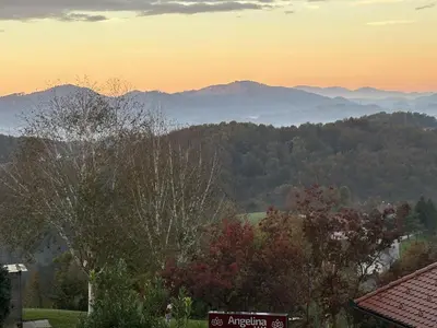 a view of the mountains at sunset from a house at B&B Villa Angelina in Rogaška Slatina