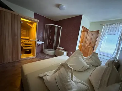 a living room with a white couch and a bathroom at B&B Villa Angelina in Rogaška Slatina