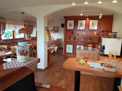 a kitchen and living room with a table and a dining room at B&B Villa Angelina in Rogaška Slatina
