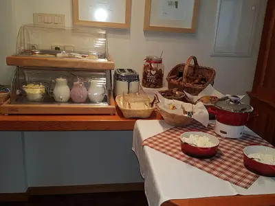 a kitchen counter with bowls and other items on a table at B&B Villa Angelina in Rogaška Slatina
