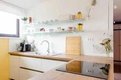 a kitchen with white cabinets and a sink at Green Point in Preserje