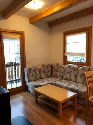 a living room with a couch and a coffee table at Apartmaji Zlata Lisička in Cerkno
