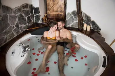 a man and a woman sitting in a bath tub at RANČ JUREŠ in Ljutomer