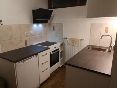 a small kitchen with a sink and a stove at Emona Apartments in Ljubljana