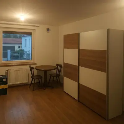 a room with a table and chairs and a window at Emona Apartments in Ljubljana