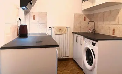 a small kitchen with a washing machine in it at Emona Apartments in Ljubljana