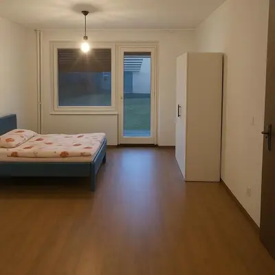 a bedroom with a bed and a large window at Emona Apartments in Ljubljana