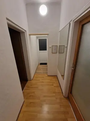 an empty hallway with a hallway leading to a door at Sašo Rooms & Apartments in Ljubljana