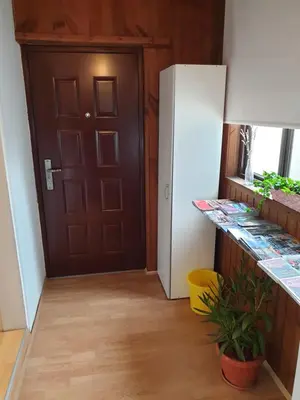 a kitchen with a refrigerator and a door at Sašo Rooms & Apartments in Ljubljana