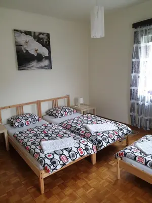 two twin beds in a room with at Sašo Rooms & Apartments in Ljubljana