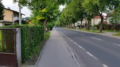 an empty street with trees on the side of the road at Sašo Rooms & Apartments in Ljubljana
