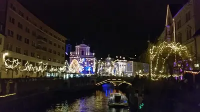a city lit up at night with christmas lights at Sašo Rooms & Apartments in Ljubljana
