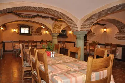 a restaurant with a table and chairs in a room at Bed & Breakfast Pr'Sknet in Šenčur