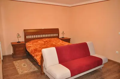 a bedroom with a bed and a couch at Bed & Breakfast Pr'Sknet in Šenčur