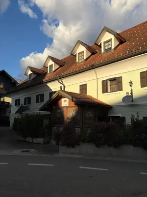 a large white building with a red roof at Bed & Breakfast Pr'Sknet in Šenčur