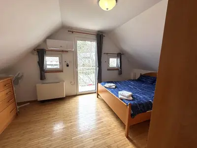 a small bedroom with a bed and a window at Apartment Emona Bled 4 in Bled