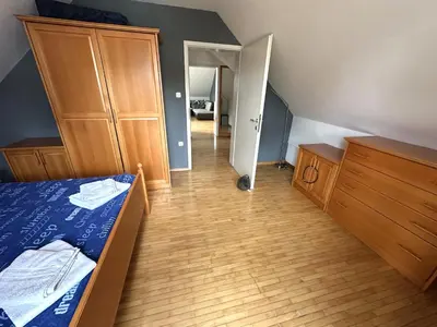 a bedroom with a bed and a wooden floor at Apartment Emona Bled 4 in Bled