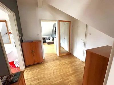 an empty room with a hallway with a wooden floor at Apartment Emona Bled 4 in Bled