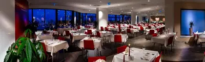 a restaurant with white tables and red chairs at Rimske Terme Resort - Hotel Zdraviliški dvor in Rimske Toplice