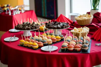 a table with several trays of cupcakes and other desserts at Rimske Terme Resort - Hotel Zdraviliški dvor in Rimske Toplice