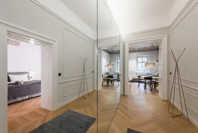 a living room with a glass door and a dining room at Apartments Rog in Ljubljana