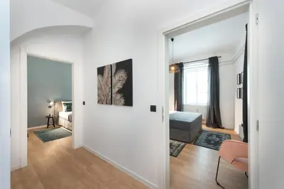a living room with a door leading to a bedroom at Apartments Rog in Ljubljana