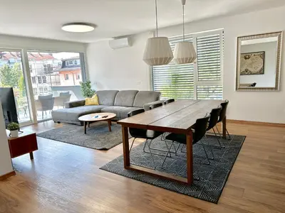 a living room with a table and a couch at Apartments Villa Popp in Ljubljana