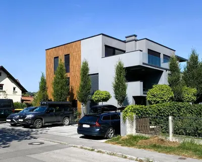 two cars parked in a parking lot in front of a building at Apartments Villa Popp in Ljubljana