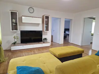 a living room with a large tv and a couch at Patricia House in Ljubljana