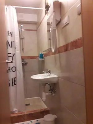 a small bathroom with a sink and a toilet at Hostel Piero in Ljubljana