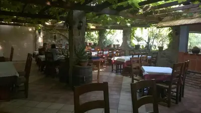 a restaurant with tables and chairs and people sitting at tables at Hostel Piero in Ljubljana