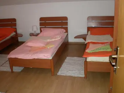 two bunk beds in a room with wooden floors at Hostel Piero in Ljubljana
