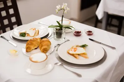 a table with plates of food and a cup of coffee at Vila Monet in Laško