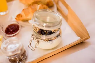 a jar of food on a tray with a plate of food at Vila Monet in Laško