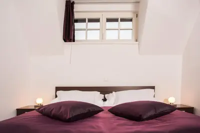 a bedroom with a bed with two pillows and a window at Vila Monet in Laško