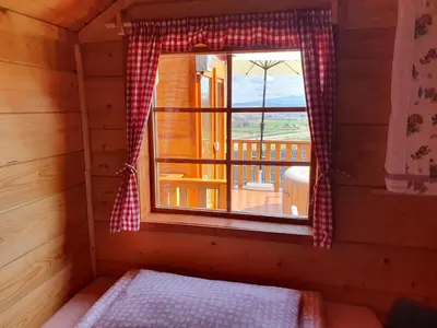 a small room with a window in a cabin at Gnezdo Vid-ik in Čatež ob Savi