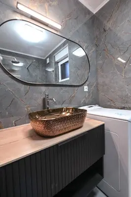 a bathroom with a sink and a mirror at Apartments in Villa Olimp in Ljubljana