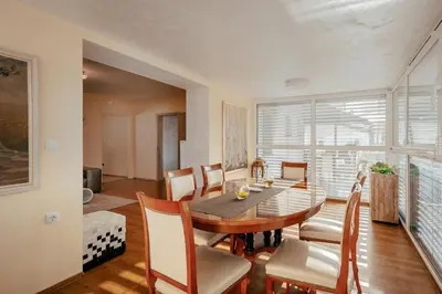 a dining room with a table and chairs at Apartments in Villa Olimp in Ljubljana